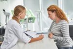 A woman learns about breast reduction surgery.