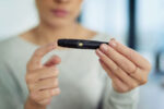 A woman manages her diabetes by using an insulin reading pen.