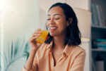 A woman drinking a cortisol cocktail for stress relief.