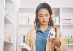 A woman looks for differences between brand name and generic medication.