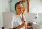 A woman does her skin care routine to keep her skin healthy.