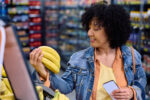 A woman buying bananas for potassium.
