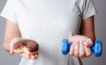 A woman wondering if exercise can erase a bad diet for weight loss.