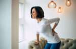 A woman experiencing chronic back pain.