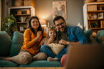 Parents and child watch a scary movie.