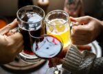 People drinking alcohol, which is connected to increasing your cancer risk.